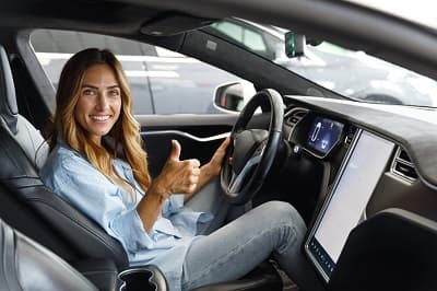 Femme qui lève le pouce dans une voiture 