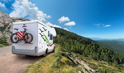 camping-car circulant sur une route de montagne en été