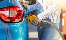 Femme qui met de l'essence dans sa voiture à la station-service